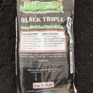 A bag of black triple is sitting on the ground.