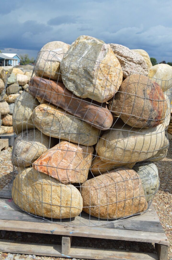 A pile of rocks sitting in front of a wall.